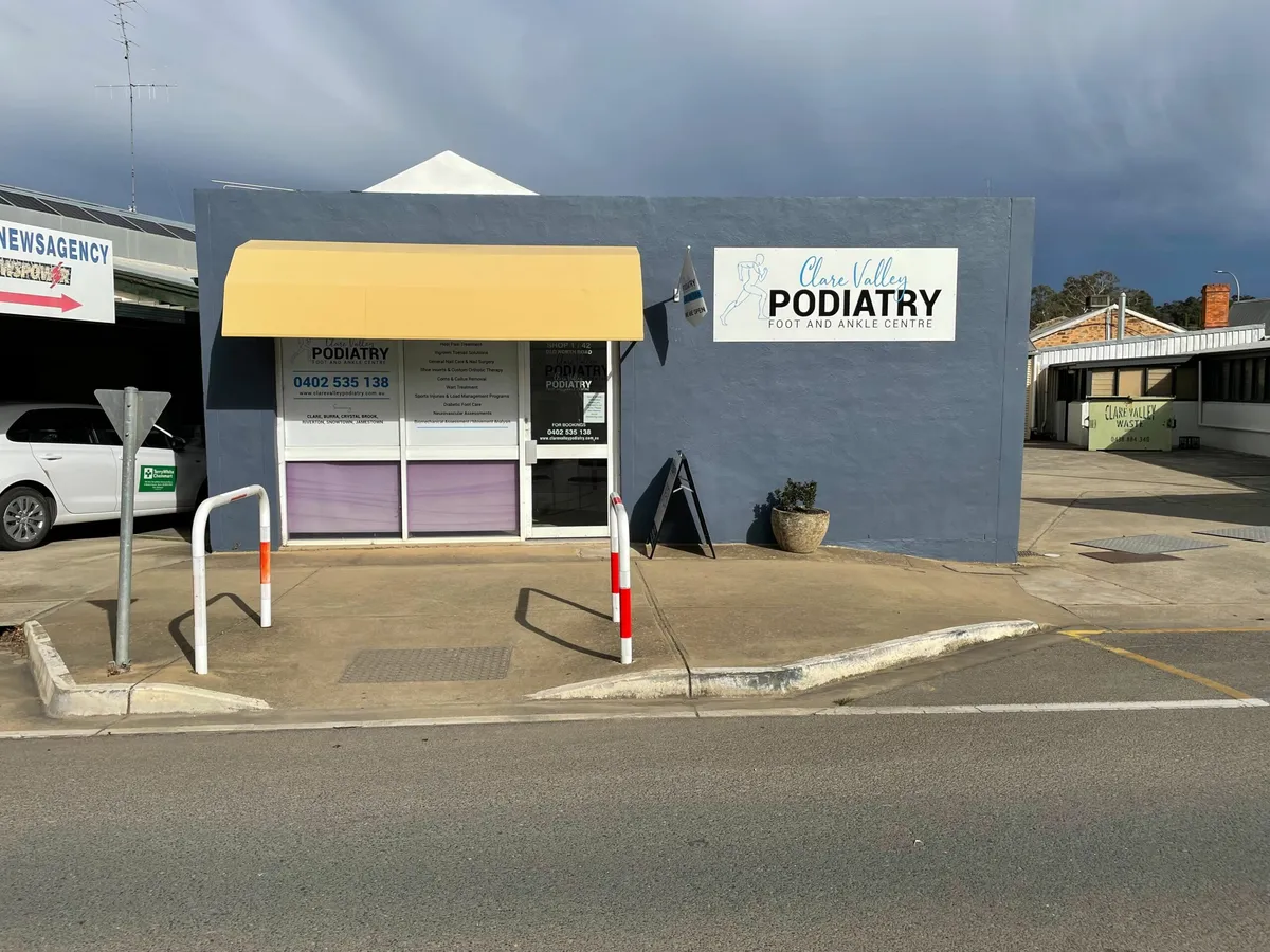 The Clare Valley Podiatry shop front with its yellow awning, seen from across Old North Road